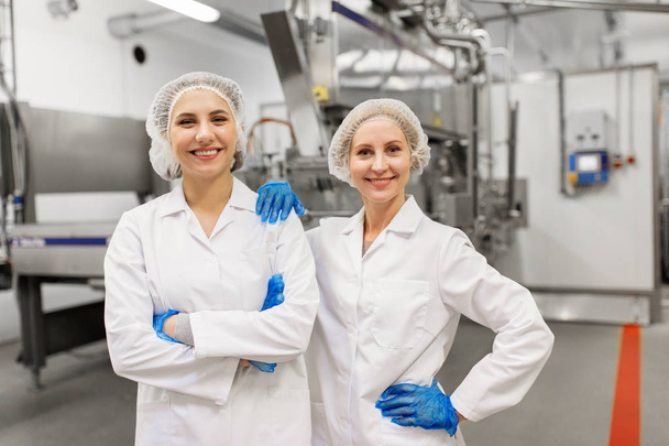 happy women technologists at ice cream factory - Фото, изображение