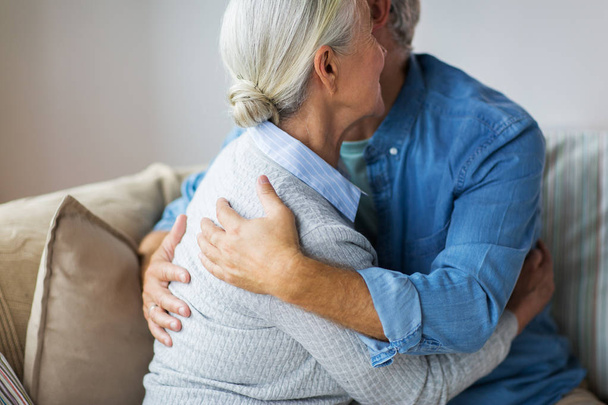 close up of happy senior couple hugging at home - Fotó, kép