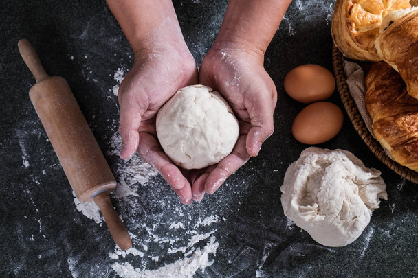 Hands preparing bread dough, Raw dough for bread with ingredient - 写真・画像