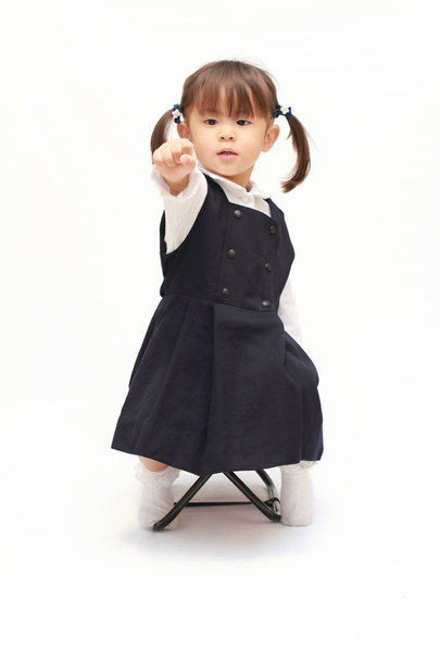 Japanese girl on the chair playing rock-paper-scissor in formal wear (2 years old) (rock) - Photo, Image
