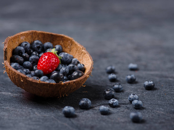 Sweet fresh strawberries and blueberries in bowl on a dark background. Food concept. - Φωτογραφία, εικόνα