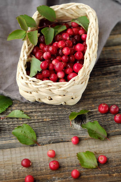 Fresh red cranberries with leaves on the table  - Valokuva, kuva