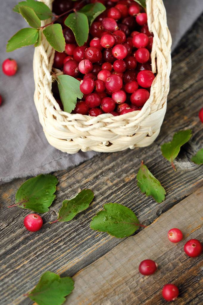 Fresh red cranberries with leaves on the table  - Photo, Image