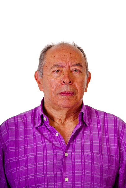 Portrait of mature man wearing a purple square t-shirt in a white background - Фото, зображення
