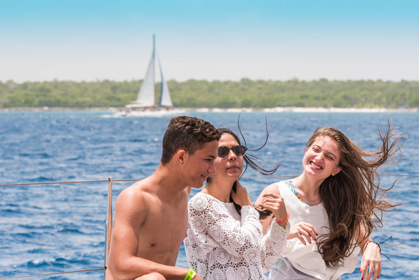 SAONA, DOMINICAN REPUBLIC - MAY 25, 2017: Funny teenagers on the deck of a yacht. Copy space for text. - Valokuva, kuva