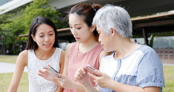 Family using mobile phone together  - Photo, Image