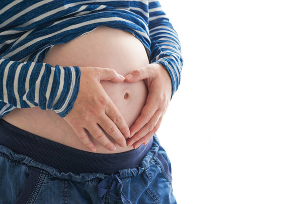 Schwangere berührt und reibt ihren Bauch - Foto, Bild