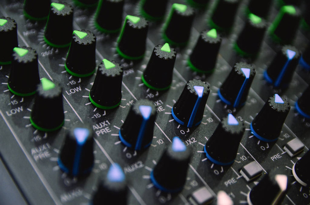 Selective focus professional audio mixing console panel. - Photo, Image