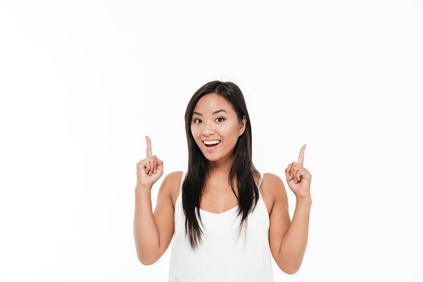 Portrait of a happy pretty asian woman pointing - Фото, зображення