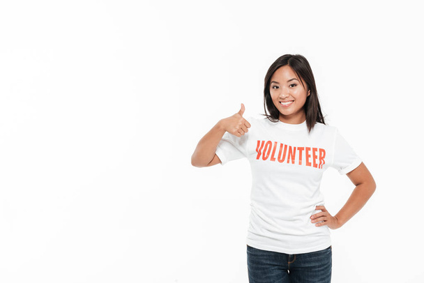 Portrait of a happy satisfied asian woman in volunteer t-shirt - Foto, imagen