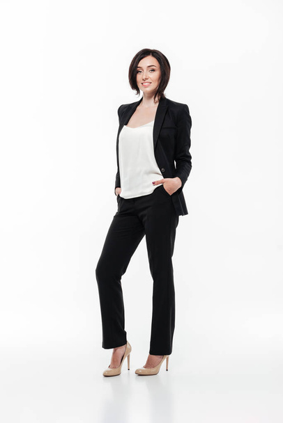 Full length portrait of a brunette businesswoman in a suit - Фото, зображення