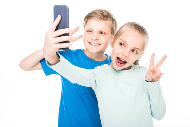 children taking selfie with smartphone - 写真・画像