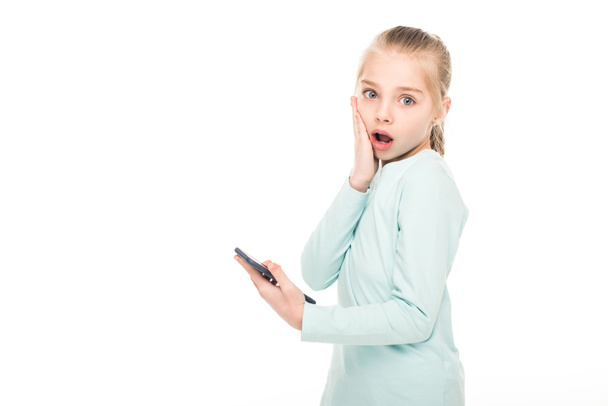 shocked child with smartphone - Foto, afbeelding