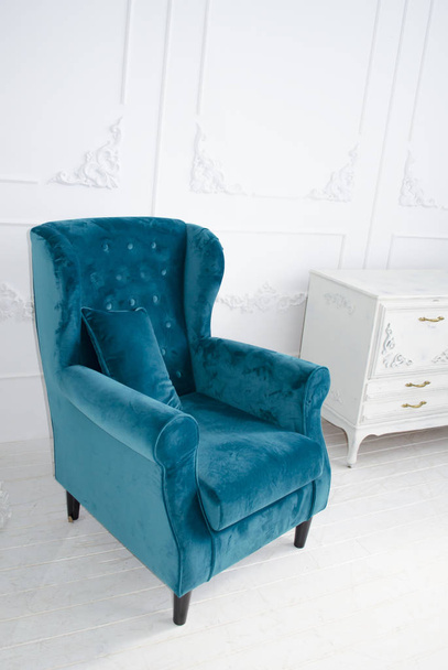 Luxurious velvet armchair of the sea waves color in a white interior. - Photo, Image