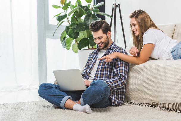 attractive couple using laptop - Photo, Image