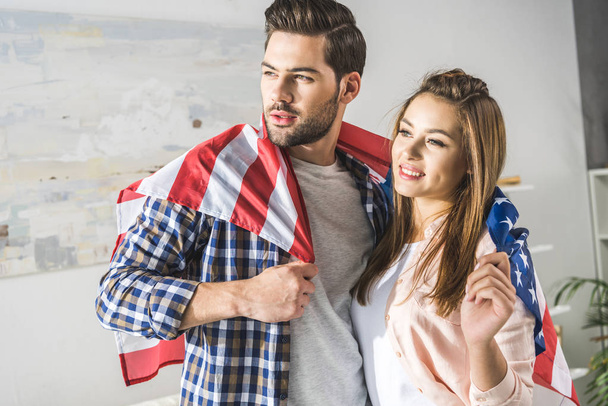 couple wrapped in American flag - Foto, imagen