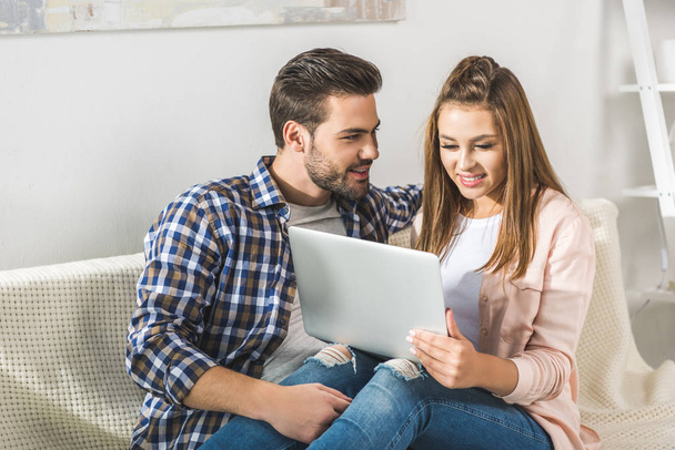 attractive couple using laptop  - Photo, Image