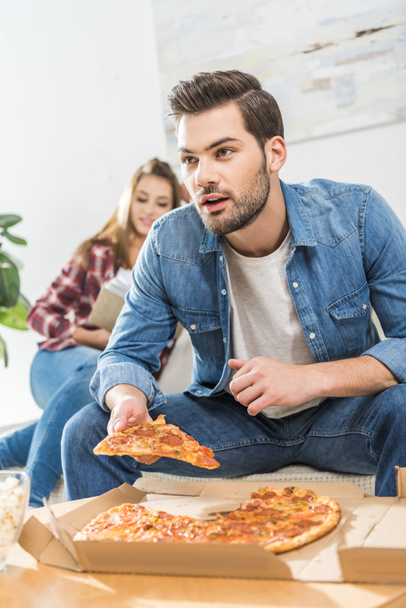 Man holding slice of pizza - Photo, Image
