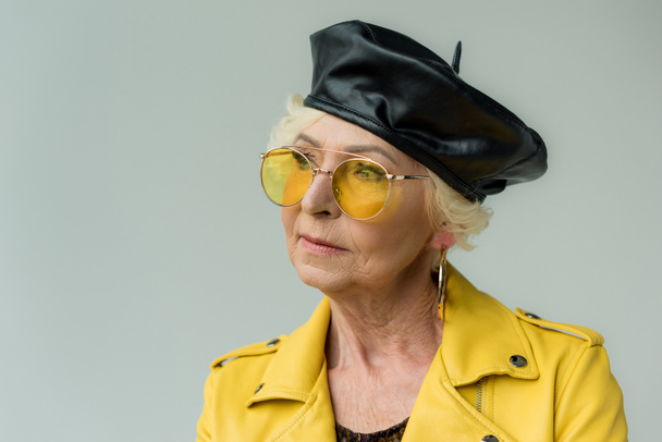 senior woman in beret and yellow sunglasses - Фото, изображение