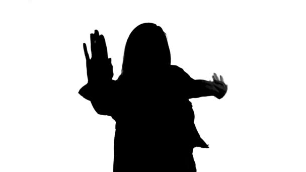 Silhouette of happy dancing woman waving bye - Video