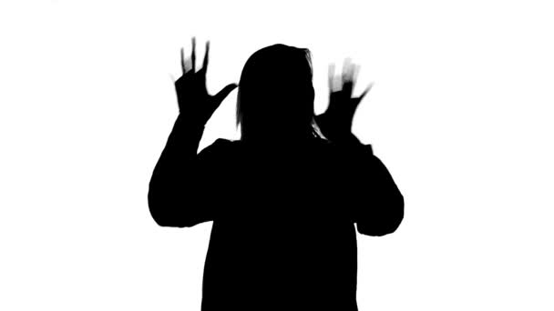 Silhouette of happy dancing woman with palms - Filmati, video