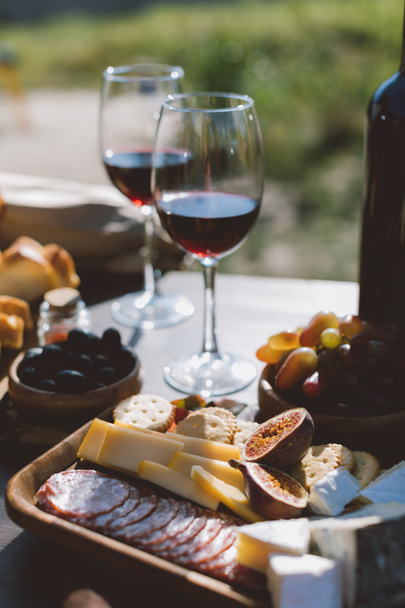 wine with wooden plate of sliced snacks - Photo, Image