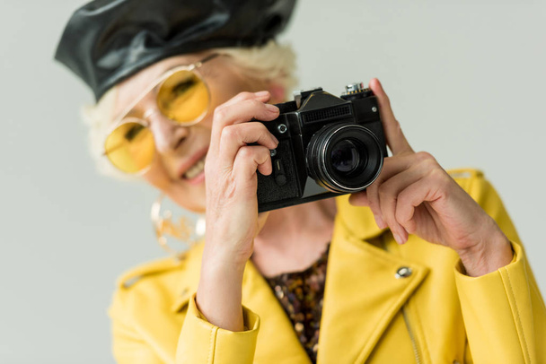 senior woman taking photo on camera - Фото, изображение