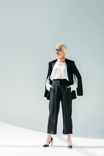 senior lady in black suit  - Фото, изображение