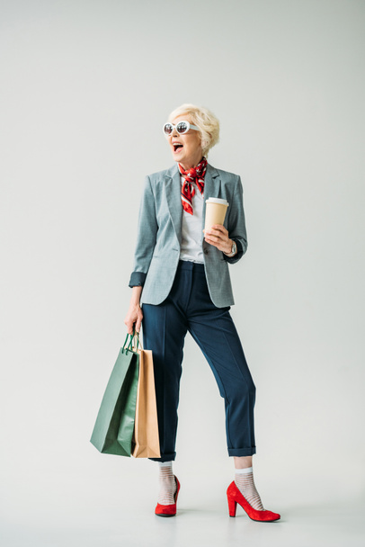 senior woman with shopping bags   - Фото, изображение