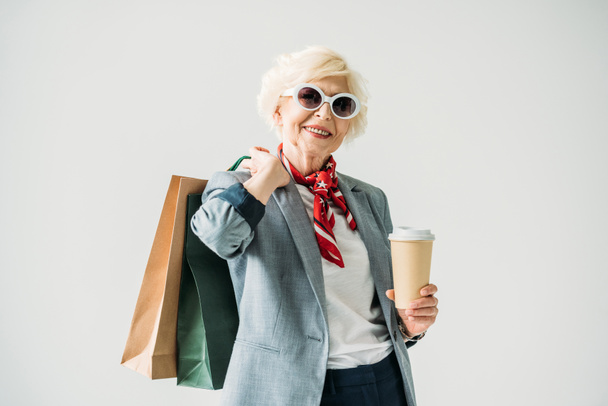 senior woman with shopping bags and coffee - Zdjęcie, obraz