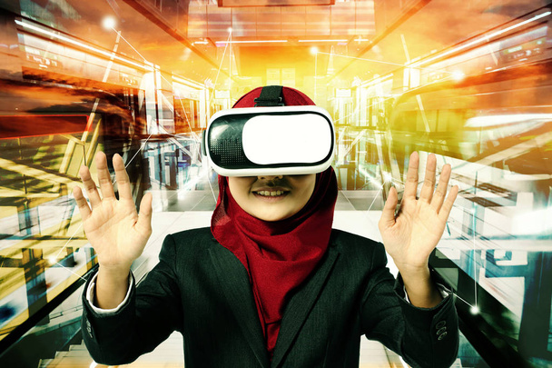 Creative ideas concept, successful young muslimah businesswomen wearing virtual reality headset  over abstract double exposure background - Photo, Image