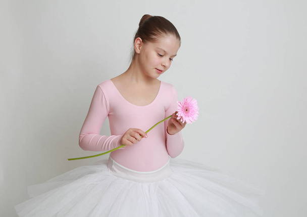 Beautiful little ballerina and pink gerbera flower - Foto, immagini