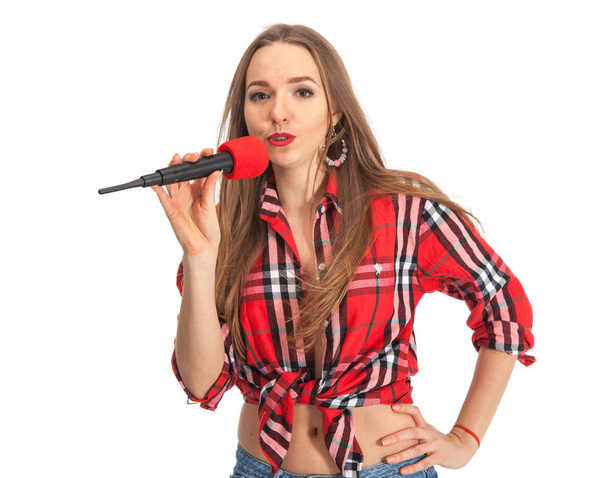 Woman singing karaoke with microphone - Фото, изображение