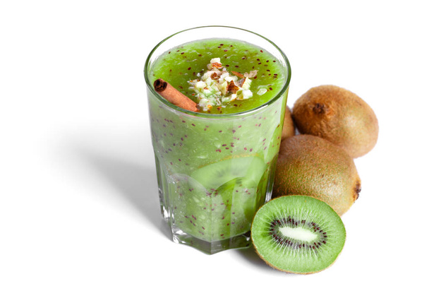 energy morning kiwi smoothie with cinnamon stick and grated almonds - Фото, изображение