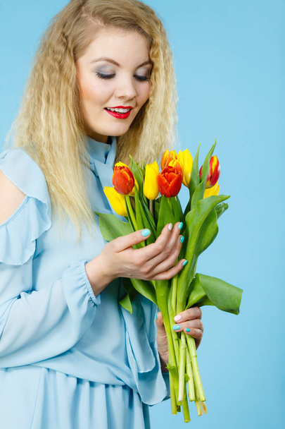 Pretty woman with red yellow tulips bunch - Valokuva, kuva