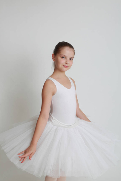 Beautiful little ballerina in studio - Фото, изображение