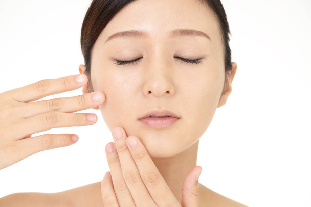 Beautiful woman doing facial massage - Photo, Image