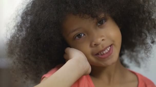 Cute African American child posing for camera and smiling, close-up, happiness - Záběry, video