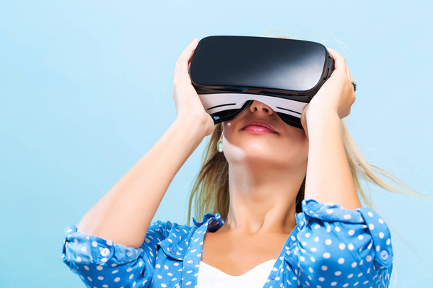 Young woman using virtual reality headset - Foto, imagen