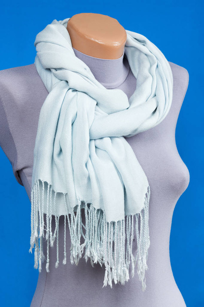 Blue scarf on mannequin isolated on blue background. - Photo, Image