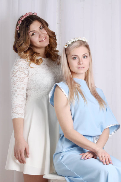 two beautiful girls in dresses with flowers in her hair  - Valokuva, kuva