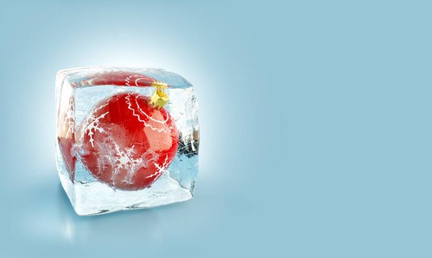 Beautiful red Christmas ball inside ice cube. - Valokuva, kuva