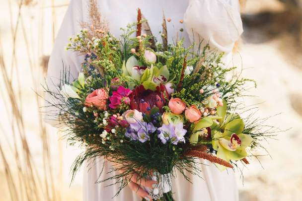 Wedding bouquet with eustoma, orchids, bellflowers, peonies and  - Photo, Image
