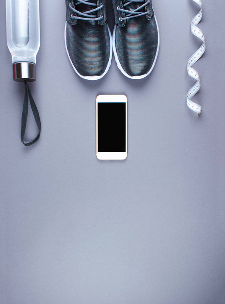 Flat lay shot of sneakers, earphones, phone.  - Foto, afbeelding