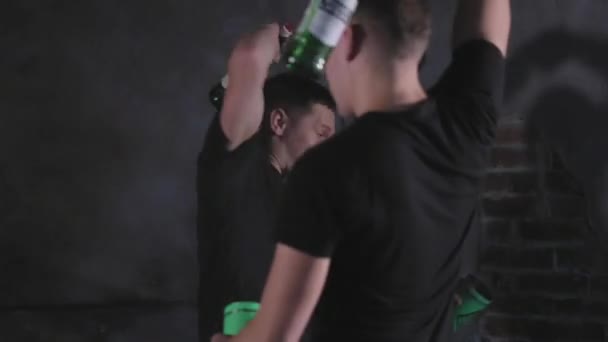 Two barmans juggling bottles and shaking cocktail at a mobile bar - Felvétel, videó