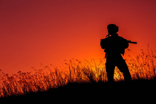 military soldier with weapons at sunset. shot, holding gun, colo - Φωτογραφία, εικόνα