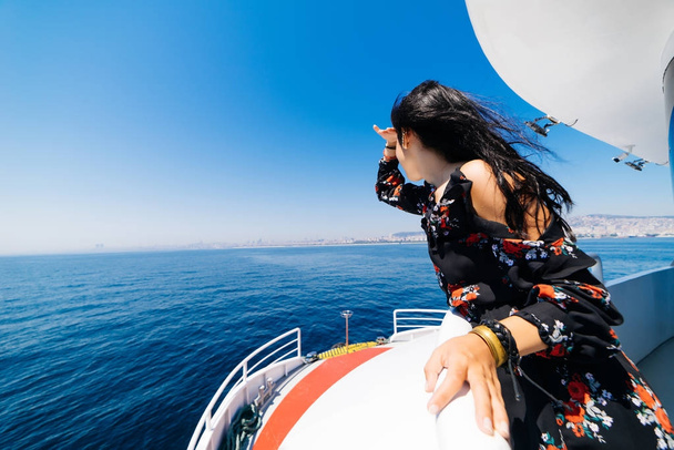 Woman looking like a capitan to a far on yacht - Фото, зображення