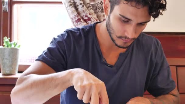 Attractive young man in restaurant eating - Video
