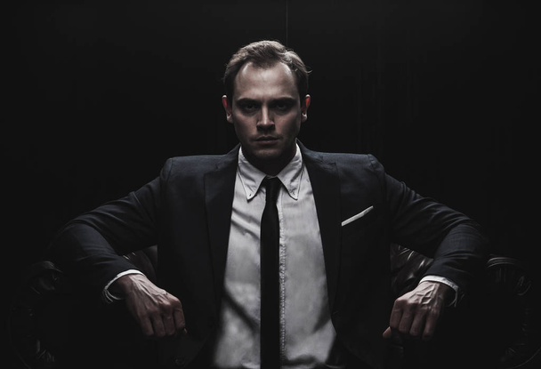Portrait of a businessman on black background - Fotó, kép