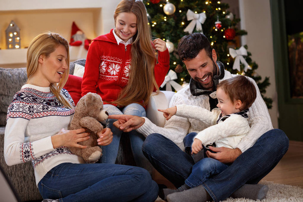 Child with parents having fun on Christmas eve - Foto, Imagem